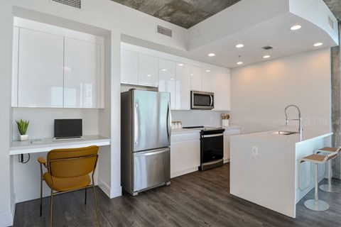 a kitchen with stainless steel appliances and desk at Element, Tampa, FL